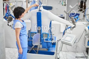 Woman worker Laundry ironed clothes on the automatic steam car a