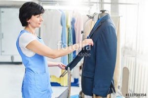 Female worker in Laundry service the process of working on unive