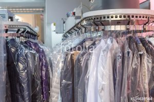 Clean clothes on hangers in the laundry room